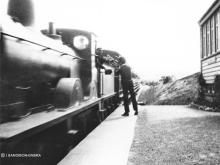 Mr Sandison signalman at Fyvie exchanges tokens with a Macduff service in the summer of 1925