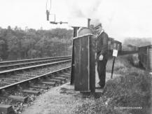 Mr Sandison signalman at Strichen exchanging tokens with a northbound goods in 1945