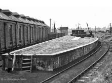 The striking shed roof at Elgin is clearly seen, a surveyor looking towards the Glen Line stands at the coaling stage with its mini hoppers, 7 July 1948