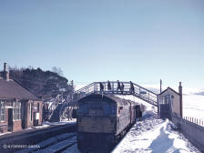 A winter scene at Grantown-on-Spey East, an unknown class 26 in charge in this shot from the winter of 1963