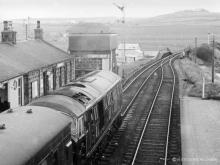 D6140 on the 1.30 to Peterhead on 24 Apr 1965, the famed 'Refresh' at Maud and its adjacent store for beer aka the water tower, are adjacent to the front of the loco.