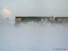 A class 26 on the 13.53 Aberdeen to Inverness passes the paper mill at Port Elphinstone on 9 Jan 1982